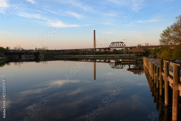 Obraz calm lake with steel bridge and boardwalk