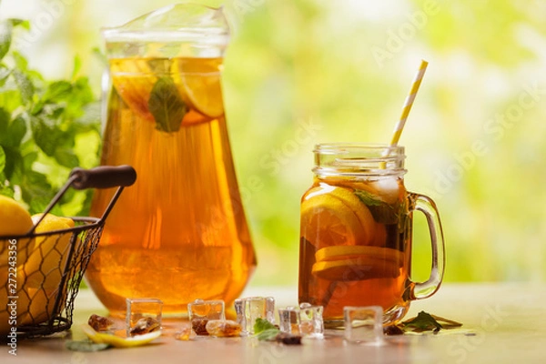 Fototapeta Iced tea with lemon and ice cubes
