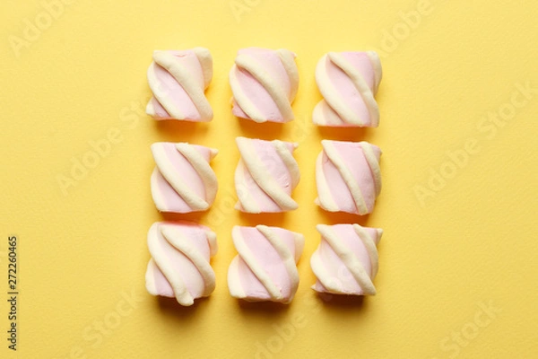 Fototapeta Abstract composition of marshmallows on a yellow background. Tov view