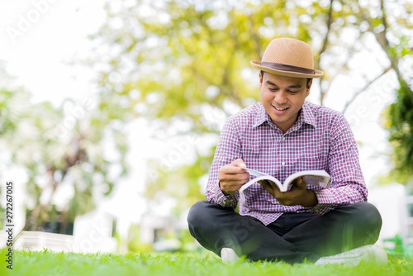 Fototapeta man reading a book.