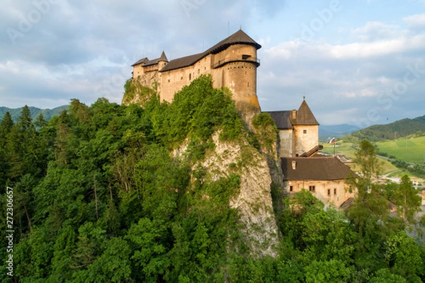 Fototapeta Orava castle - Oravsky Hrad in Oravsky Podzamok in Slovakia. Medieval stronghold on extremely high and steep cliff. Aerial view in summer at sunset