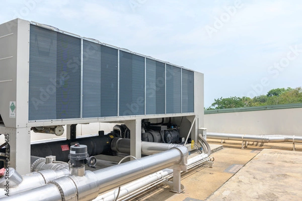 Obraz air conditioning units on rooftop with aluminium pipe housing 