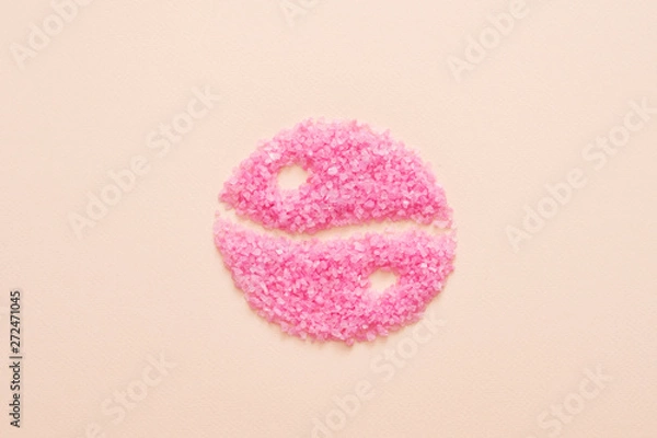 Fototapeta Beauty and health balance. Top view of pink bath salt crystals shaped in yin yang symbol over peach background. Copy space.