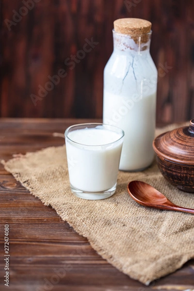 Obraz Homemade kefir, yogurt with probiotics in a glass on table Probiotic cold fermented dairy drink Trendy food and drink Copy space Rustic style.