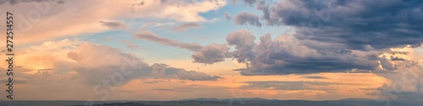 Fototapeta Dramatic light through the clouds against the backdrop of an exciting, bright stormy sky at sunset. panorama, natural composition
