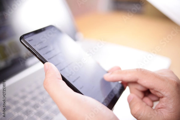 Fototapeta Businessman Holding and Using Smart Phone