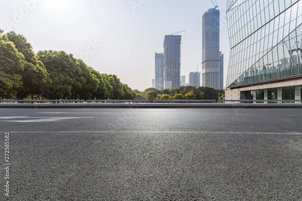 Fototapeta Panoramic skyline and modern business office buildings with empty road,empty concrete square floor