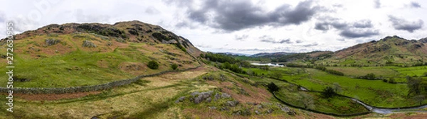 Fototapeta Aerial over the lake district with mountains and hills and dramatic sky, England panoramic