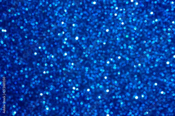 Fototapeta blue Sparkling Lights Festive background with texture. Abstract Christmas twinkled bright bokeh defocused and Falling stars. Winter Card or invitation