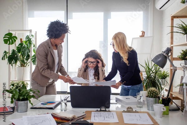 Fototapeta Three multiethnic woman at the office try to solve problems at work