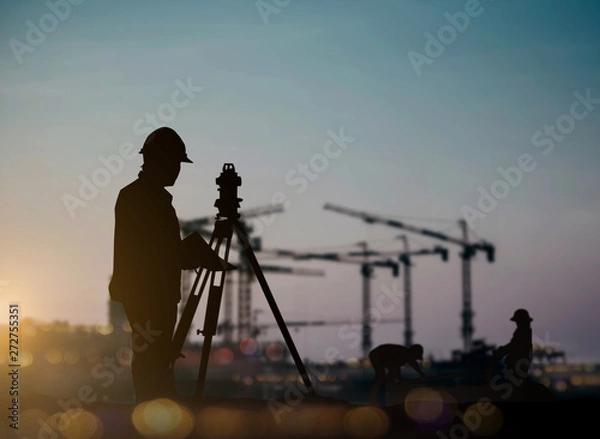 Obraz silhouette engineer looking Loaders and trucks in a building site over Blurred construction worker on construction site