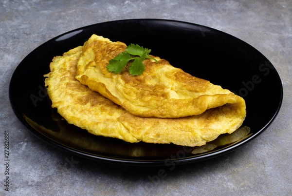 Fototapeta Omelette with tomatoes slide, coriander and scallion.