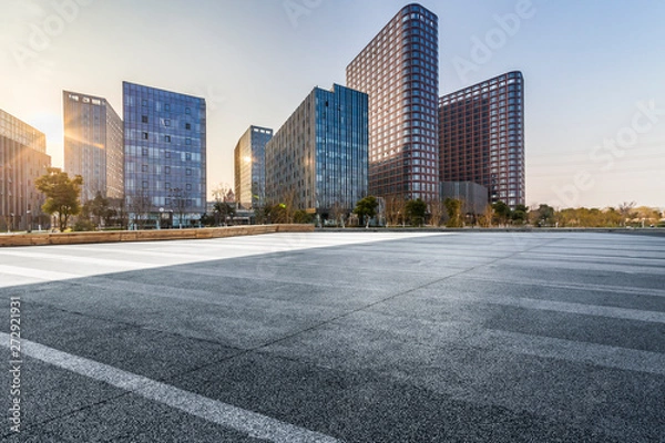 Fototapeta Panoramic skyline and modern business office buildings with empty road,empty concrete square floor
