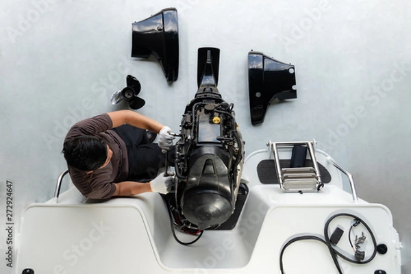 Obraz Repairing engines on aluminum boats , The technician is removing the boat parts to make the paint