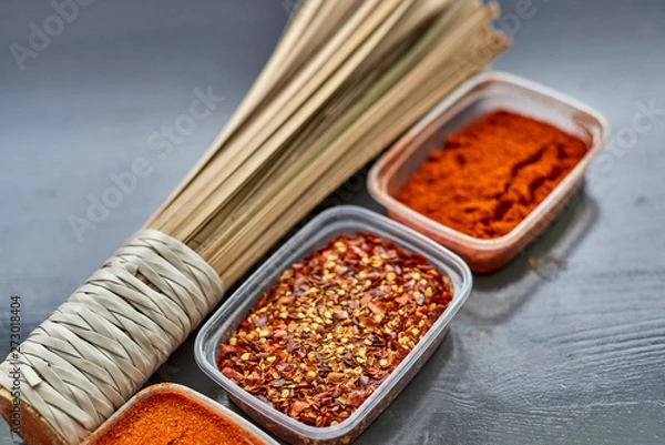 Fototapeta Spices in plastic containers with bamboo brush