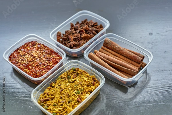Fototapeta Spices in plastic containers with bamboo brush
