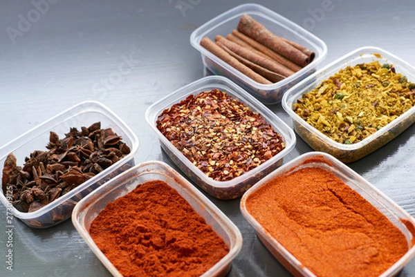 Fototapeta Spices in plastic containers with bamboo brush