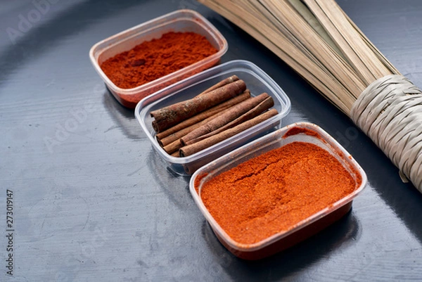 Fototapeta Spices in plastic containers with bamboo brush