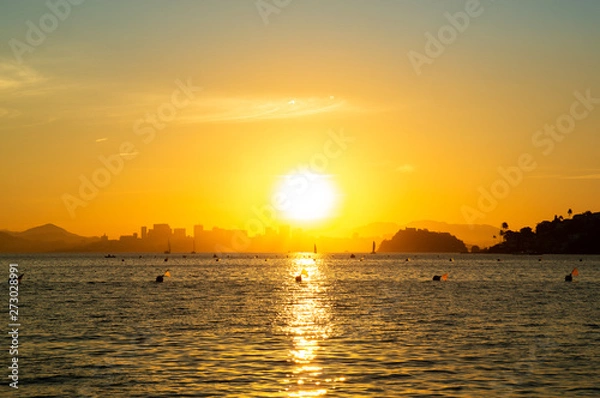 Fototapeta Sunset at the beach with reflection in the sea