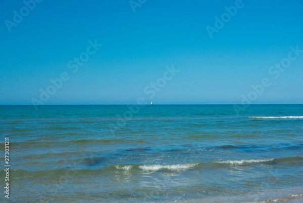 Fototapeta the blue sky over the calm sea with the reflection of sunlight. Calm sea harmony of calm water surface. Sunny sky and calm blue ocean.