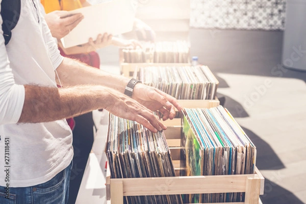 Obraz Man browsing vinyl album on sale. Beautiful male hands in the frame.