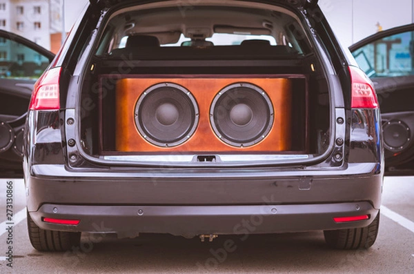 Fototapeta Rear View of a Car, Trunk and Front Doors Opened, With Installed Car Audio System, Sound Speakers and Subwoofer Sound Speakers in a Wooden Box.