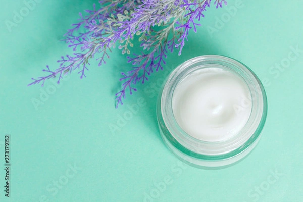 Fototapeta open can of cream on bright green background