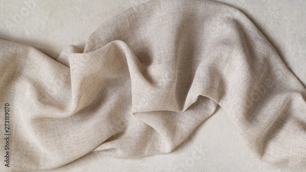 Fototapeta Flap of fine linen or hamp fabric on a gray background