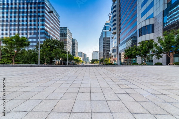Fototapeta Panoramic skyline and modern business office buildings with empty road,empty concrete square floor