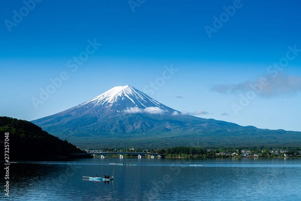 Obraz Fuji mountain and Kawaguchiko lake in morning, fog flow on the air and people do activity.