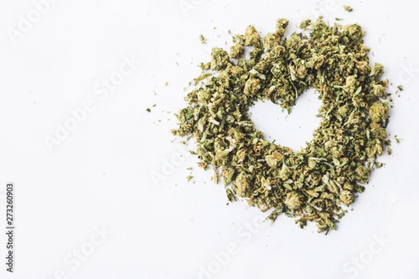 Obraz Heart made of crushed up marijuana herb isolated on white background