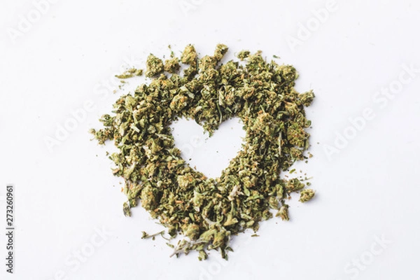 Obraz Heart made of crushed up marijuana isolated and centered on white background 