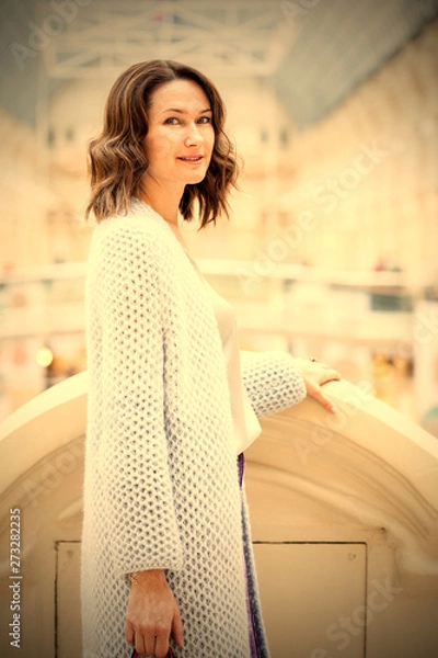 Obraz Beautiful middle-aged woman in a light knitted coat