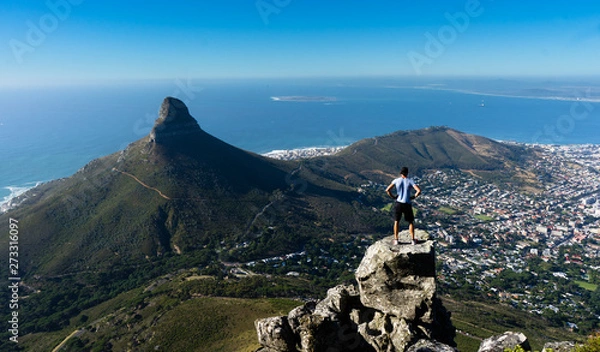 Fototapeta A hiker looking out over Cape Town from the top of Table Mountain
