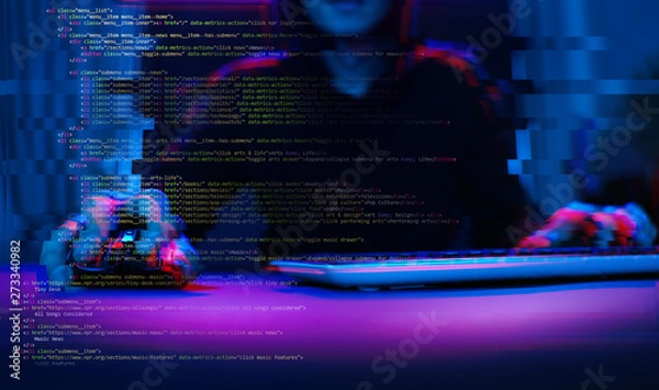 Fototapeta Hacker working with computer in dark room with digital interface around. Image with glitch effect.