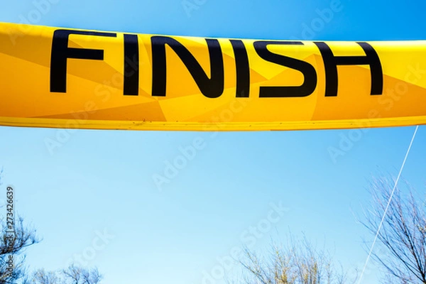 Fototapeta Word Finish on a yellow banner against a blue sky.