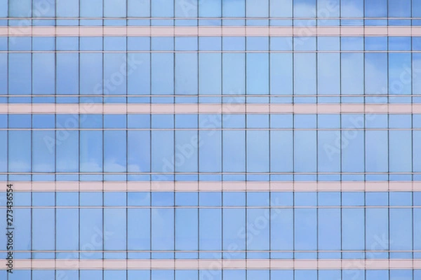 Fototapeta modern office building elevation. glass curtain wall repeating pattern reflecting cloud in the sky. city people in the architectural box.