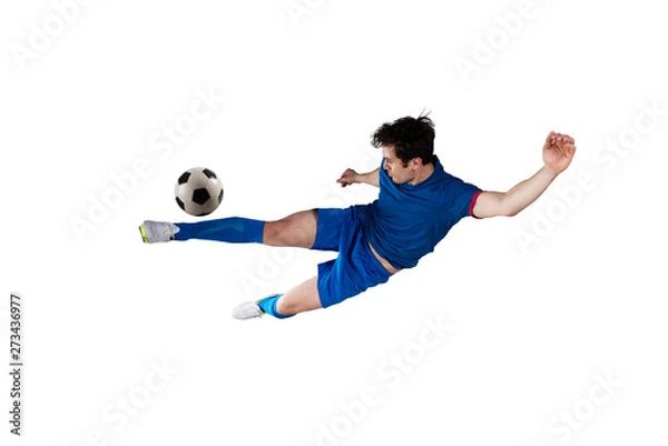 Fototapeta Football scene at night match with player kicking the ball with power. Isolated on white background