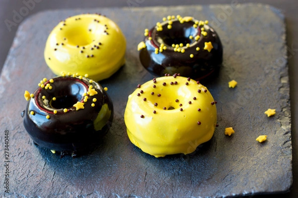 Fototapeta donuts in a glaze mix on a graphite stand