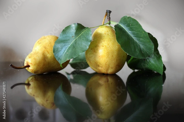 Fototapeta Two ripe yellow pears lying on the table
