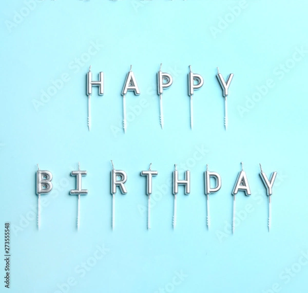 Fototapeta Flat lay composition with birthday candles on color background