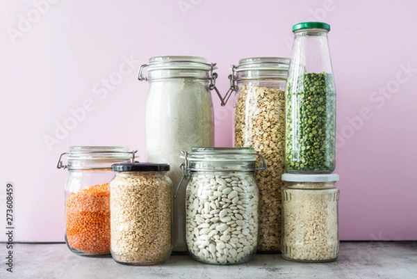 Fototapeta Variety of grains and legumes in glass jars. Zero waste storage concept