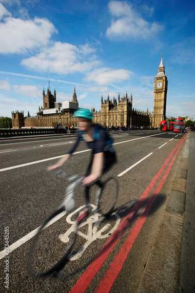 Obraz Fast moving London bicycle commuter crossing Westminster Bridge.