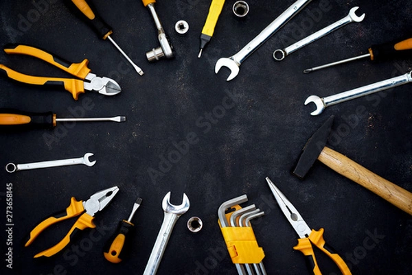 Fototapeta construction tools in wooden box in black background