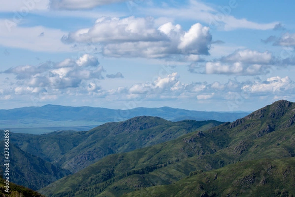 Obraz Natural landscape. Beautiful cumulus clouds float above a mountain valley.
