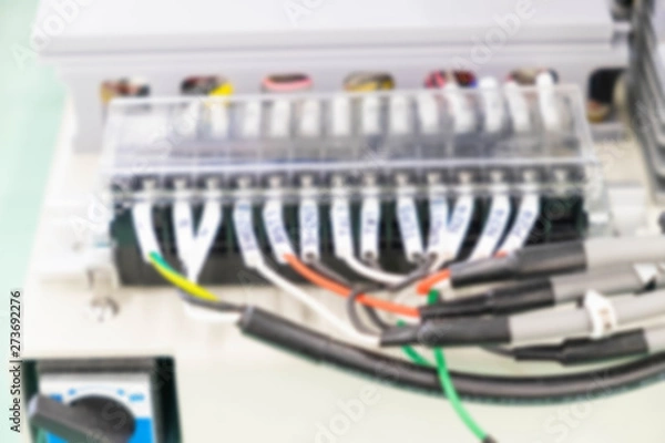 Fototapeta Abstract blur image of Cable connections on electronic equipment with bokeh for background usage.