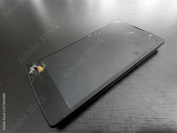 Obraz broken phone (cellphone, smartphone or mobilephone) on dark background