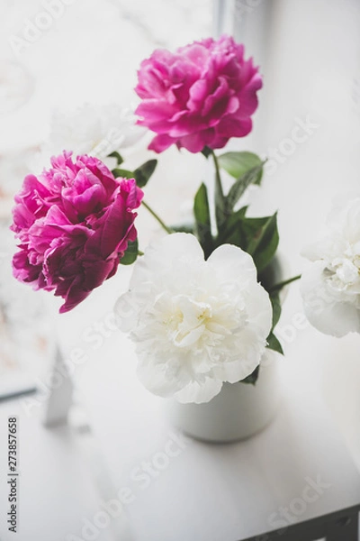 Obraz Purple and white peony flowers bouquet in vase on window sill, top view, selective focus