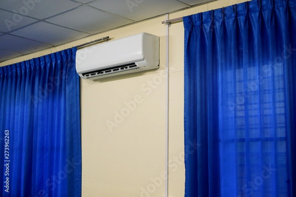 Obraz Air Conditioner between Window with Blue Curtains