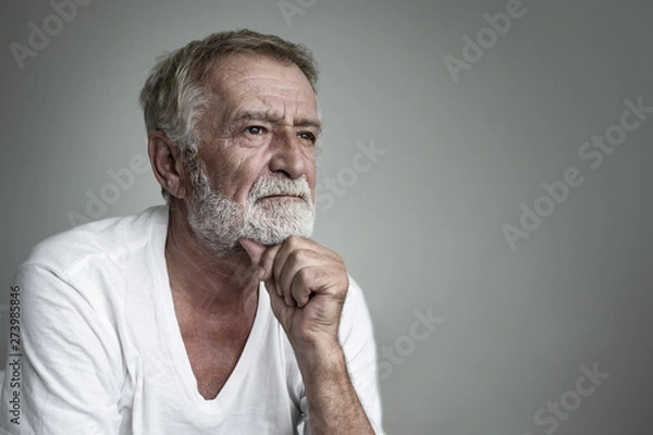 Fototapeta senior man thinking or try to remember alone closeup